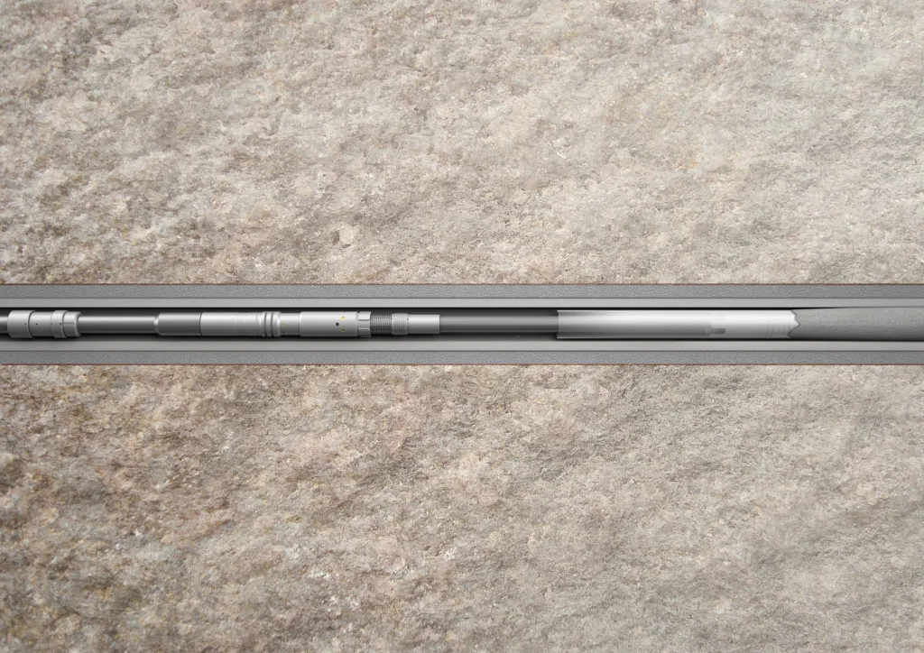 Silver smartphone lying face down on a textured beige surface, showing the side buttons and slim profile.
