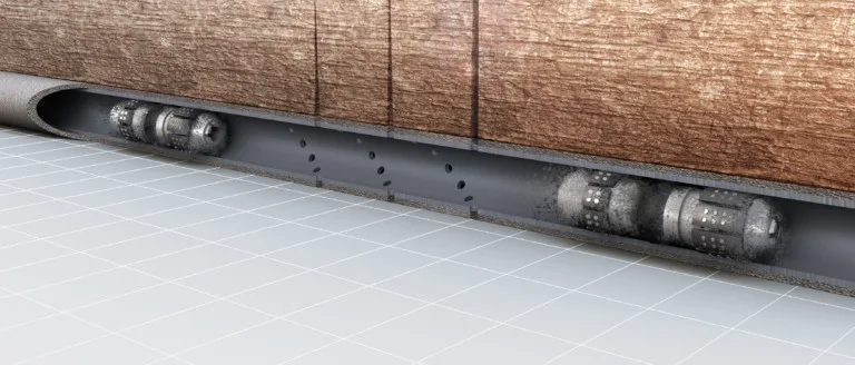Close-up of a sliding door mechanism with visible rollers and track system mounted beneath a wooden panel.