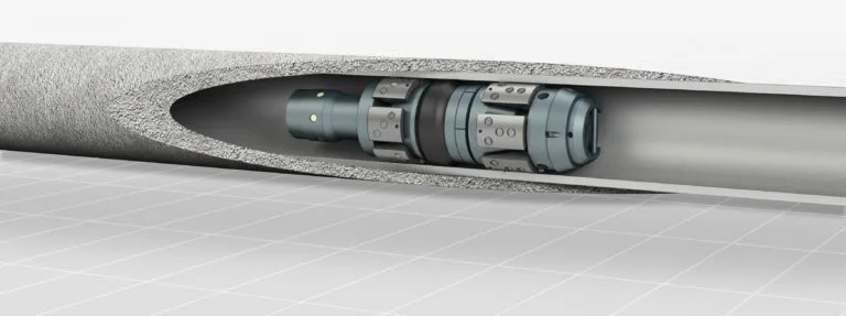 Cutaway view of a downhole tool installed inside a drilled oil well casing, showcasing internal mechanical components.