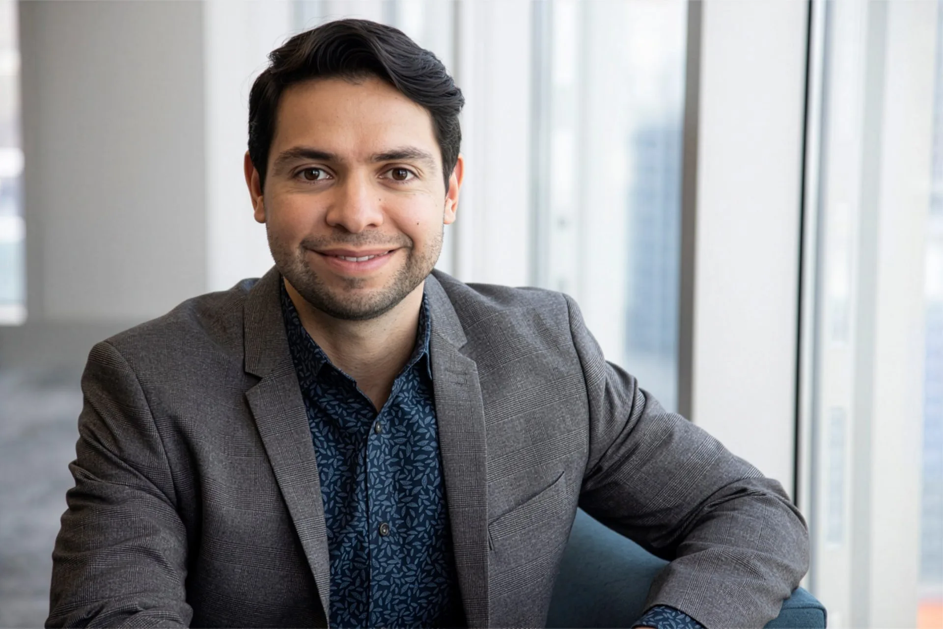 Portrait of Pablo Munguia Bravo by a window with natural light.
